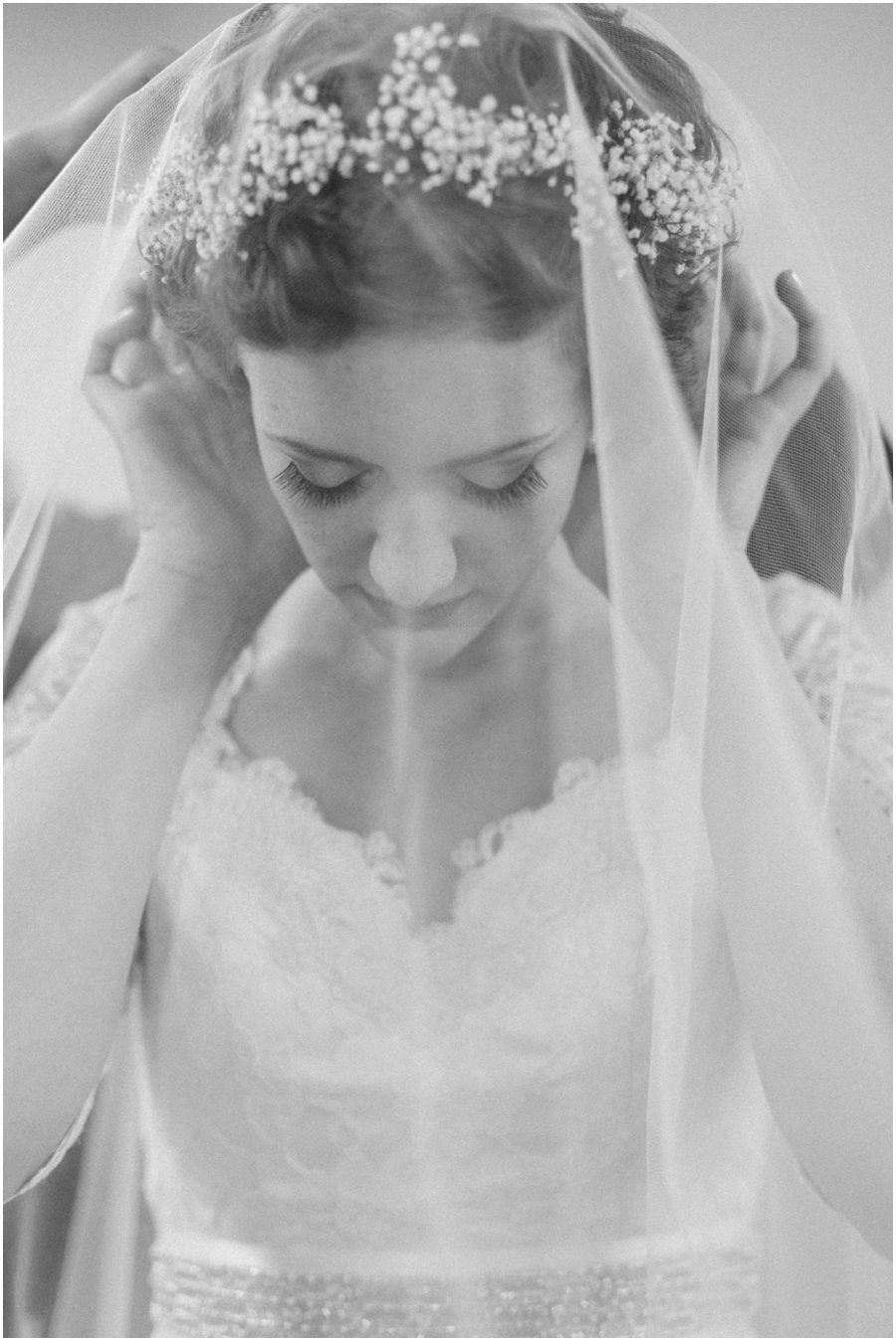 photo of a bride with her veil covering her face