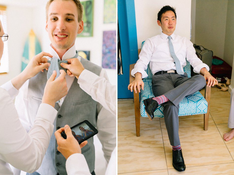 Fun wedding photo of groomsmen watching a video to tie a bow tie. Destination wedding at the Postcard Inn on the Beach by Catherine Ann Photography