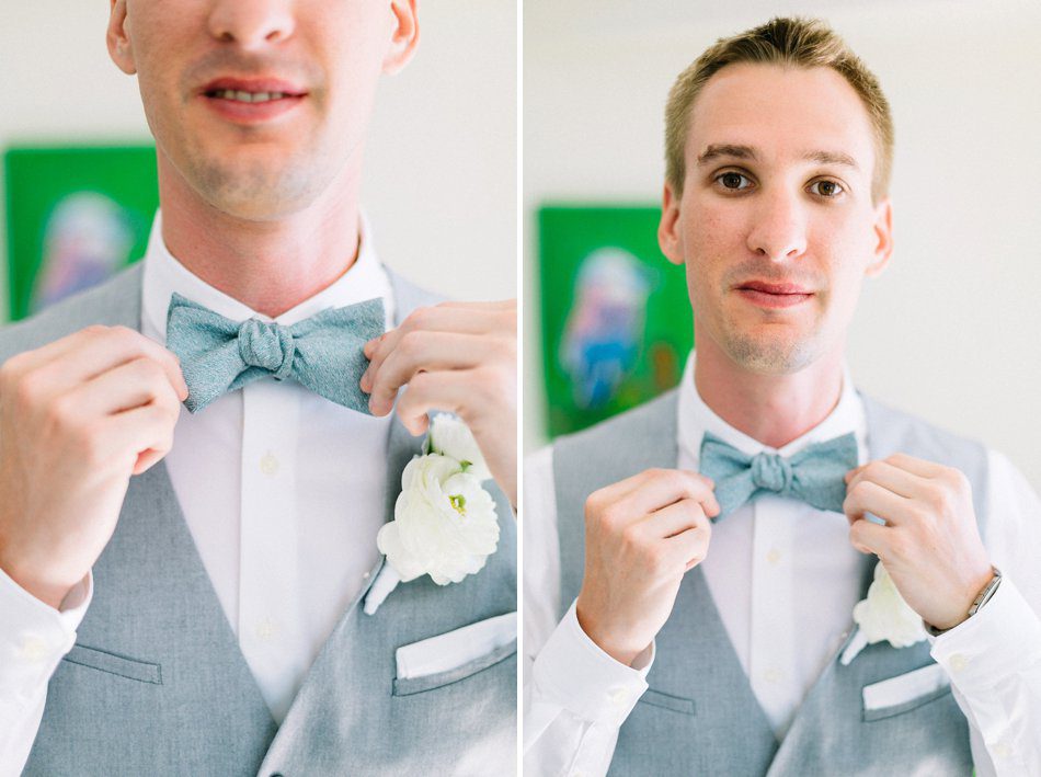 Natural light groom portrait fixing his bow tie at the Post Card Inn by Catherine Ann Photography