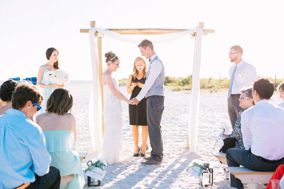 Sunset beach ceremony photo in Tampa FL. Destination wedding at the Postcard Inn on the Beach by Catherine Ann Photography