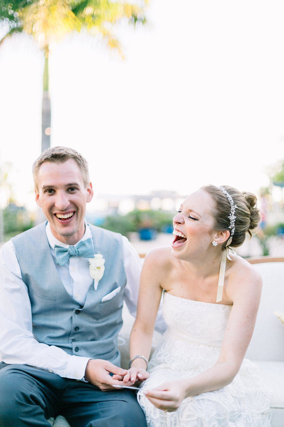 Candid wedding photo of bride and groom laughing. Destination wedding at the Postcard Inn on the Beach by Catherine Ann Photography