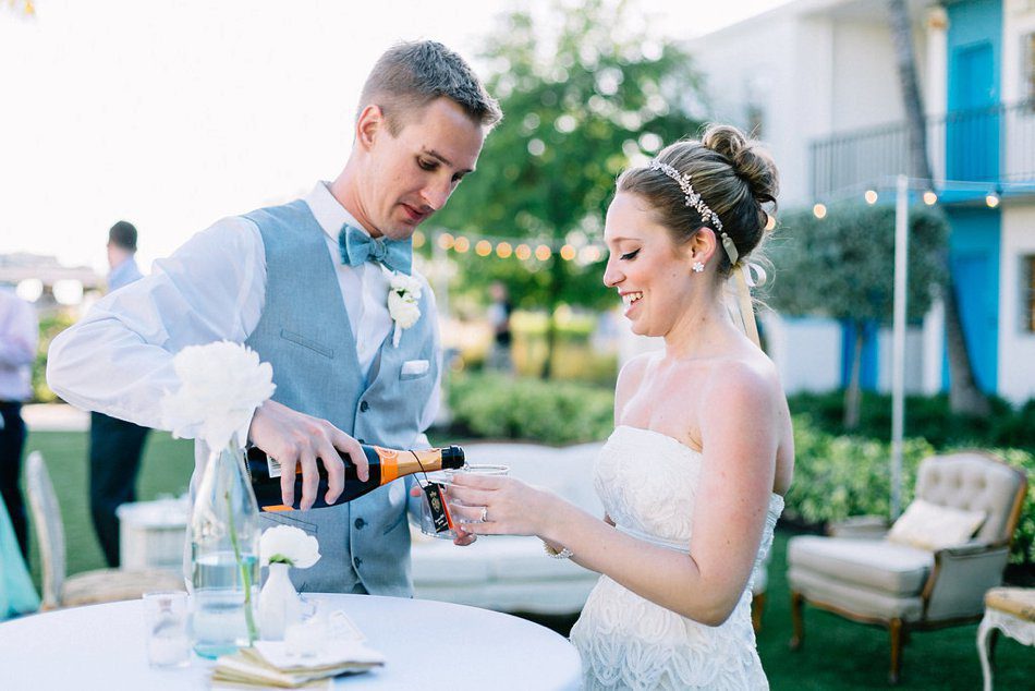 Photo of groom pouring the bride some champagne