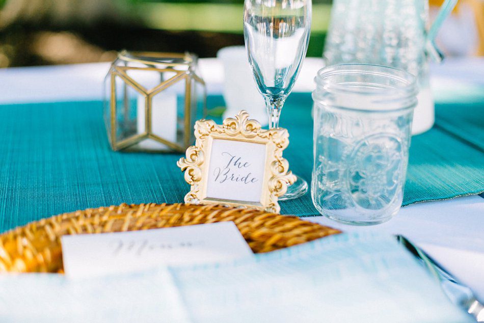 Blue and gold vintage beach wedding decor inspiration photo. Gold frame as escort cards. Destination wedding at the Postcard Inn on the Beach by Catherine Ann Photography