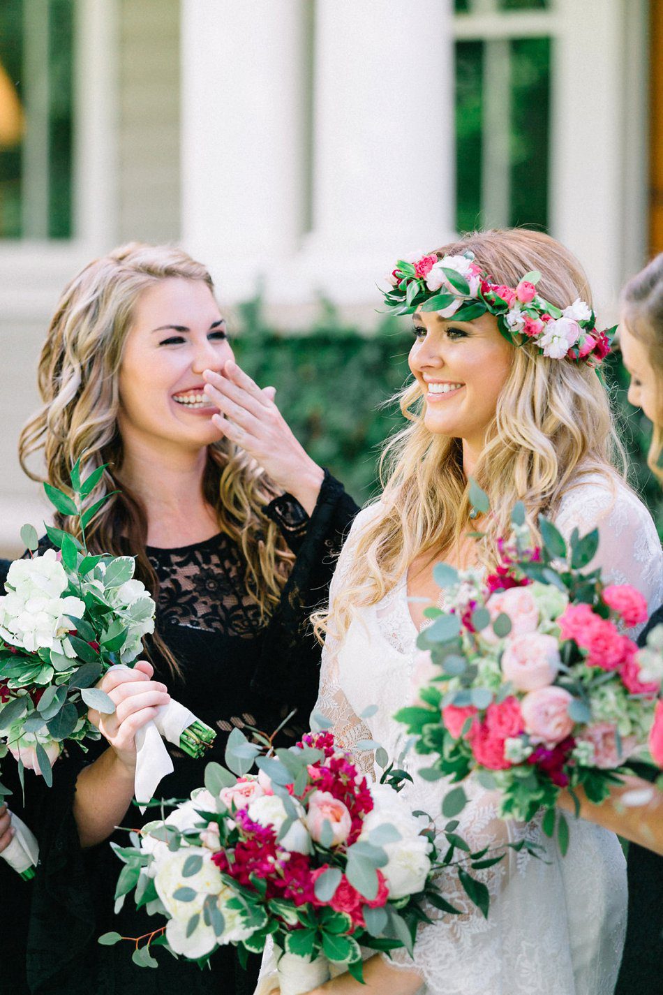 candid moment of bride and maid of honor laughing