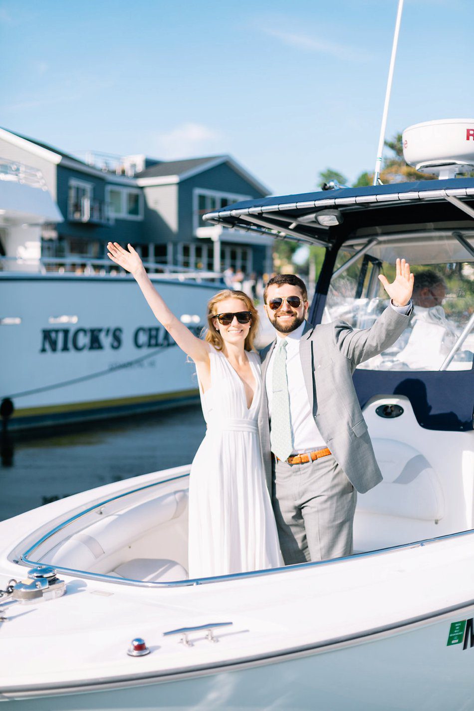 photo of bride and groom wearing sunglasses on a boat Kennebunkport River Club Wedding Photos destination wedding photographer Catherine Ann Photography