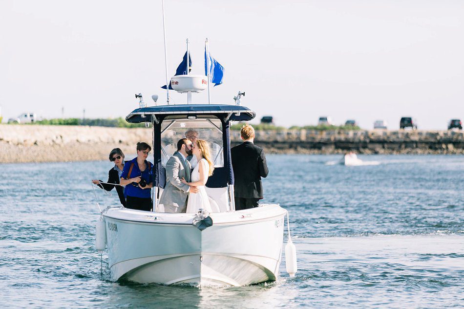 photo of couple kissing on a boat Kennebunkport River Club Wedding Photos destination wedding photographer Catherine Ann Photography