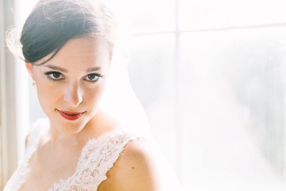 natural light bridal portrait with red lips and lace wedding gown