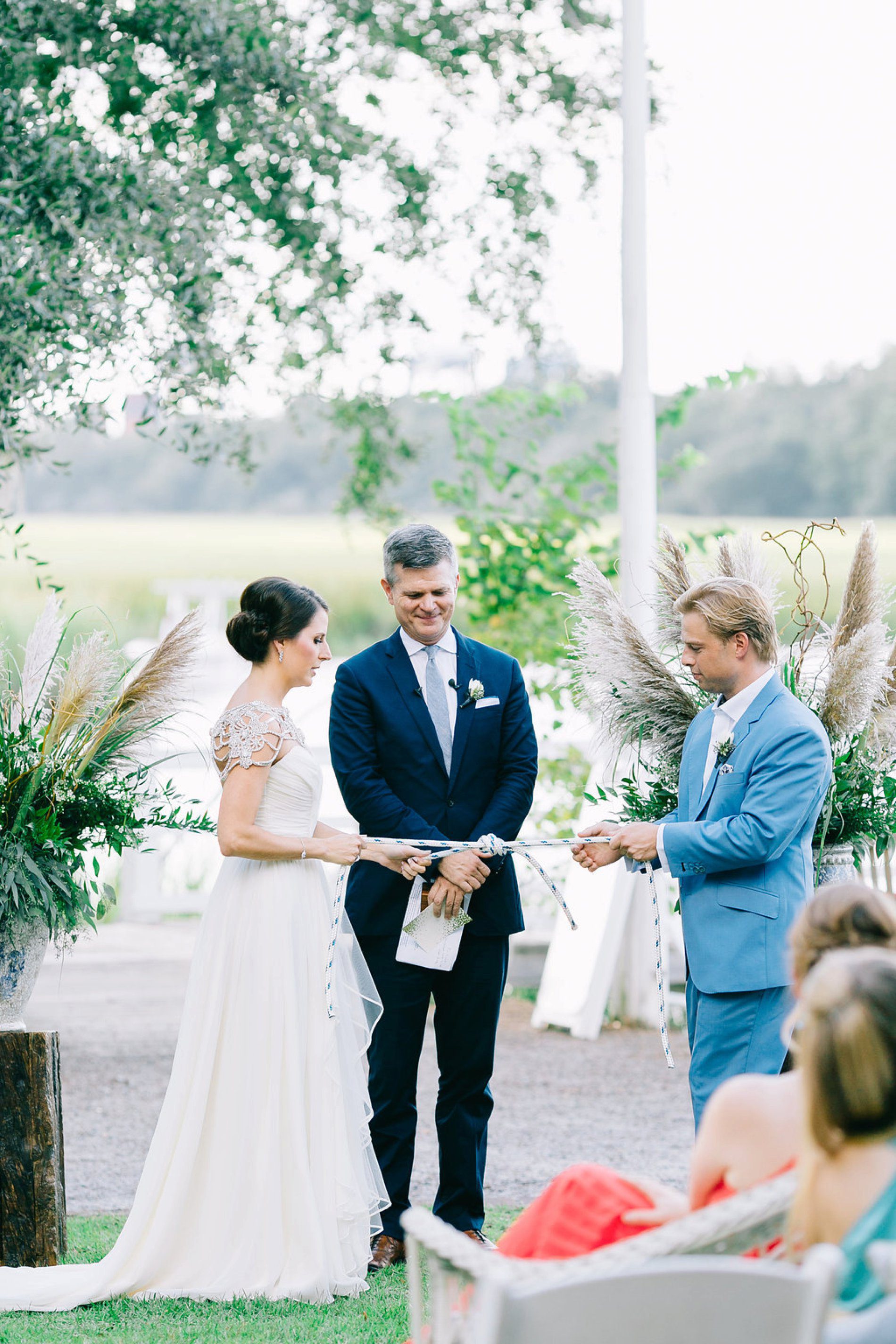 Bride and groom tying a nautical knot during their ceremony in Charleston 