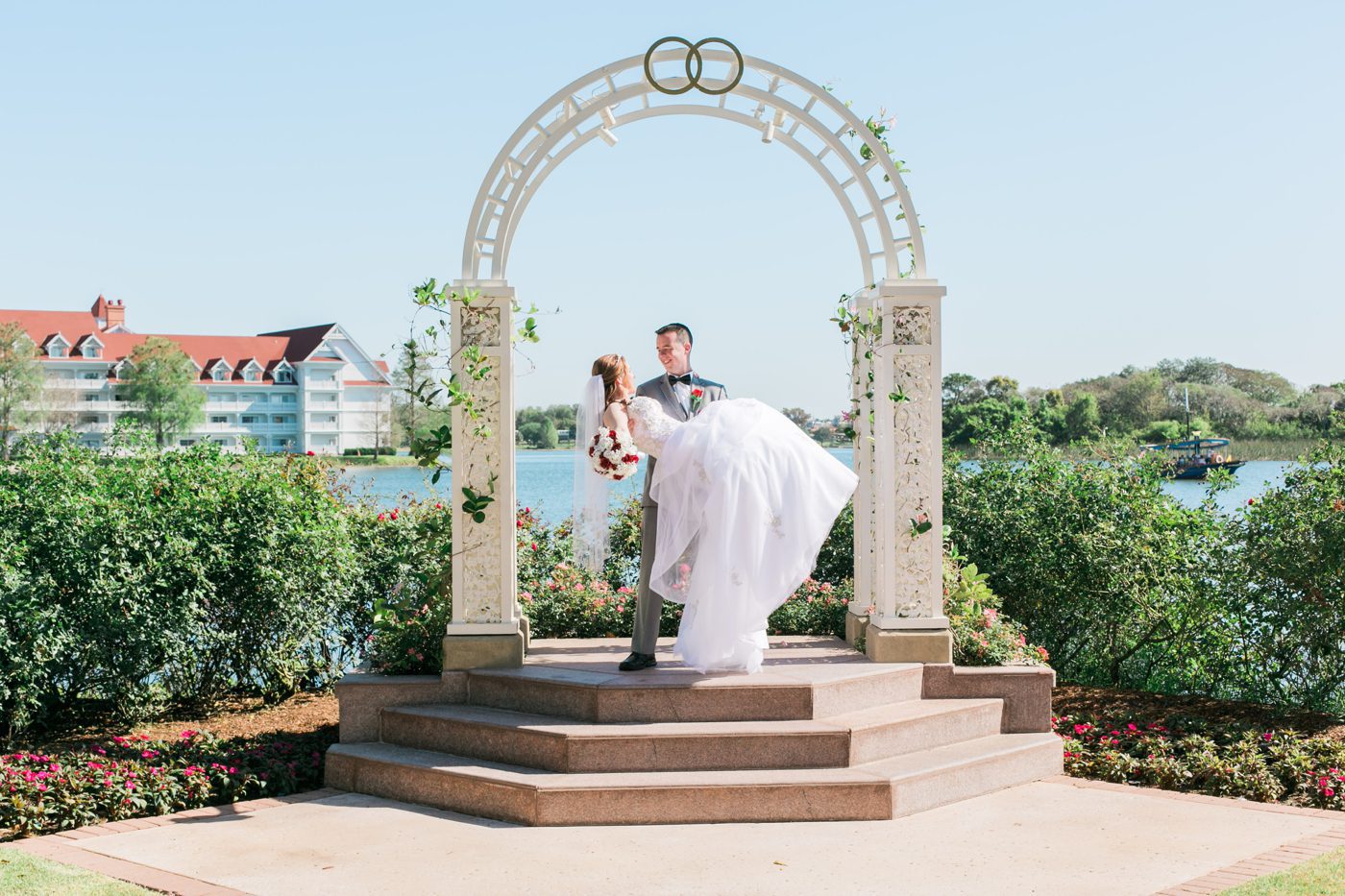 Photo of groom carrying the bride like a princess at Disney World