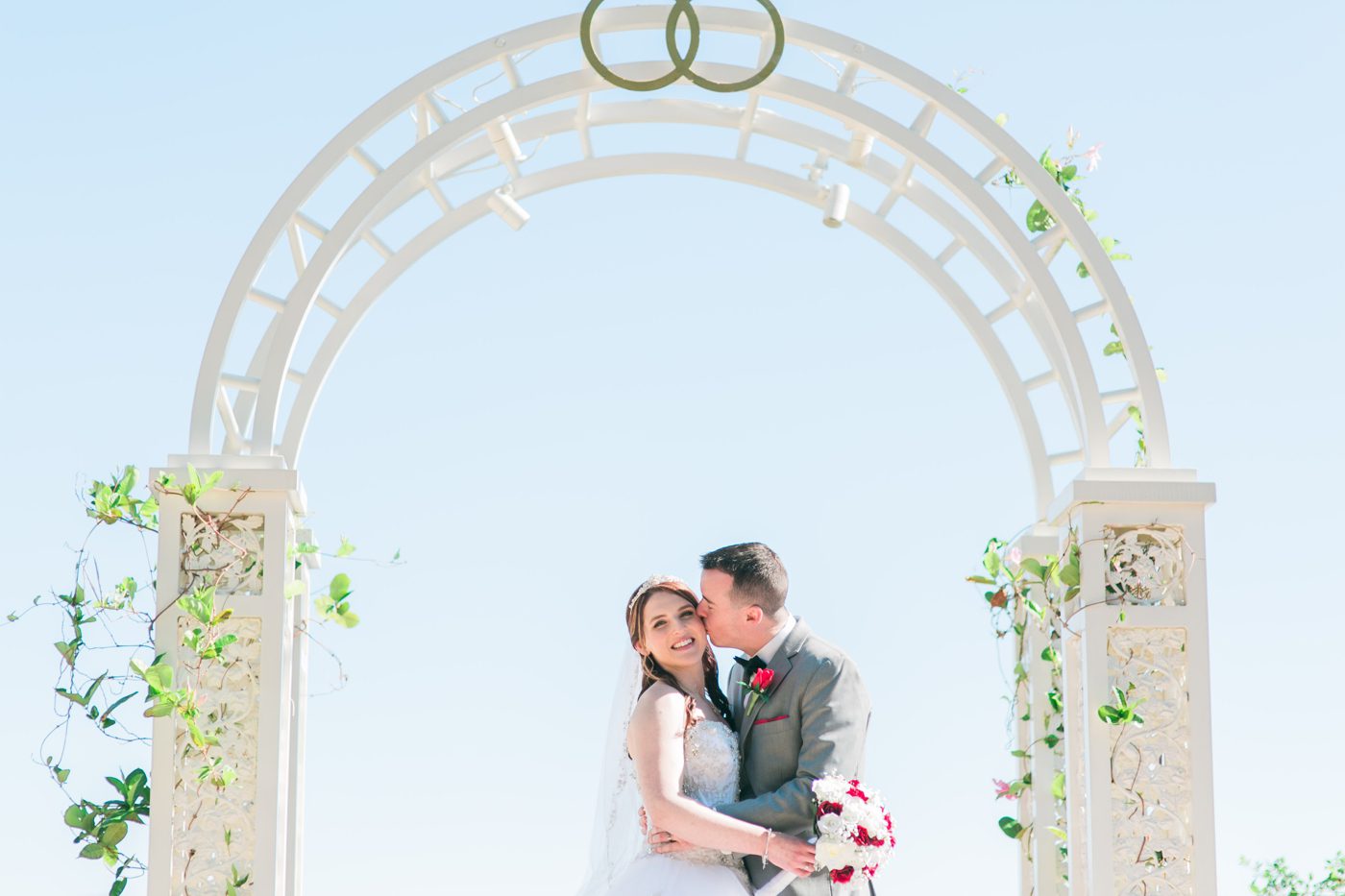 Bride and groom portraits under the archway at Disney World 