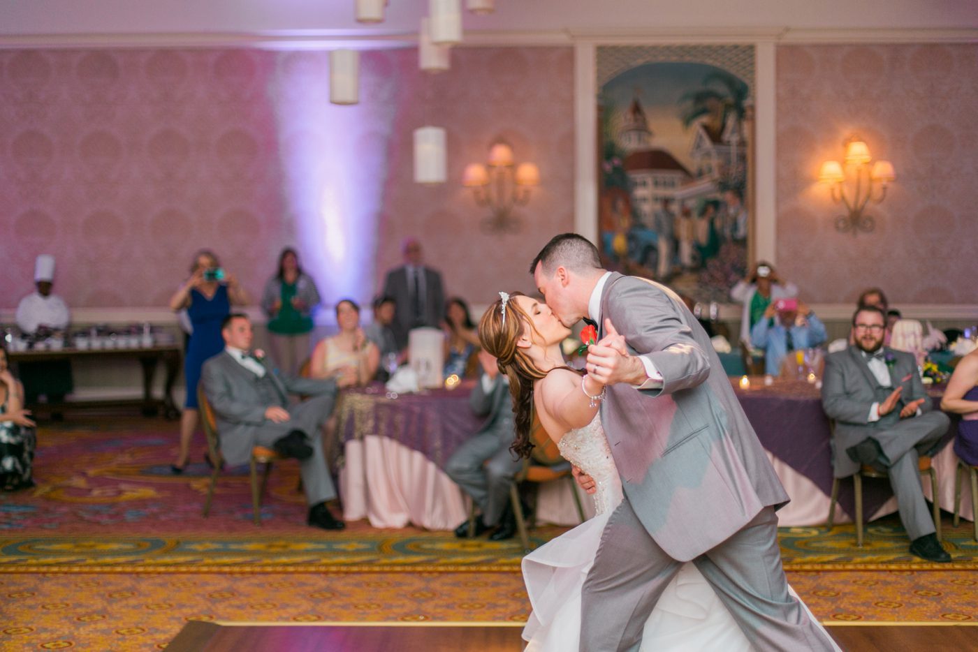 Groom dipping the bride during their first dance at Disney World 