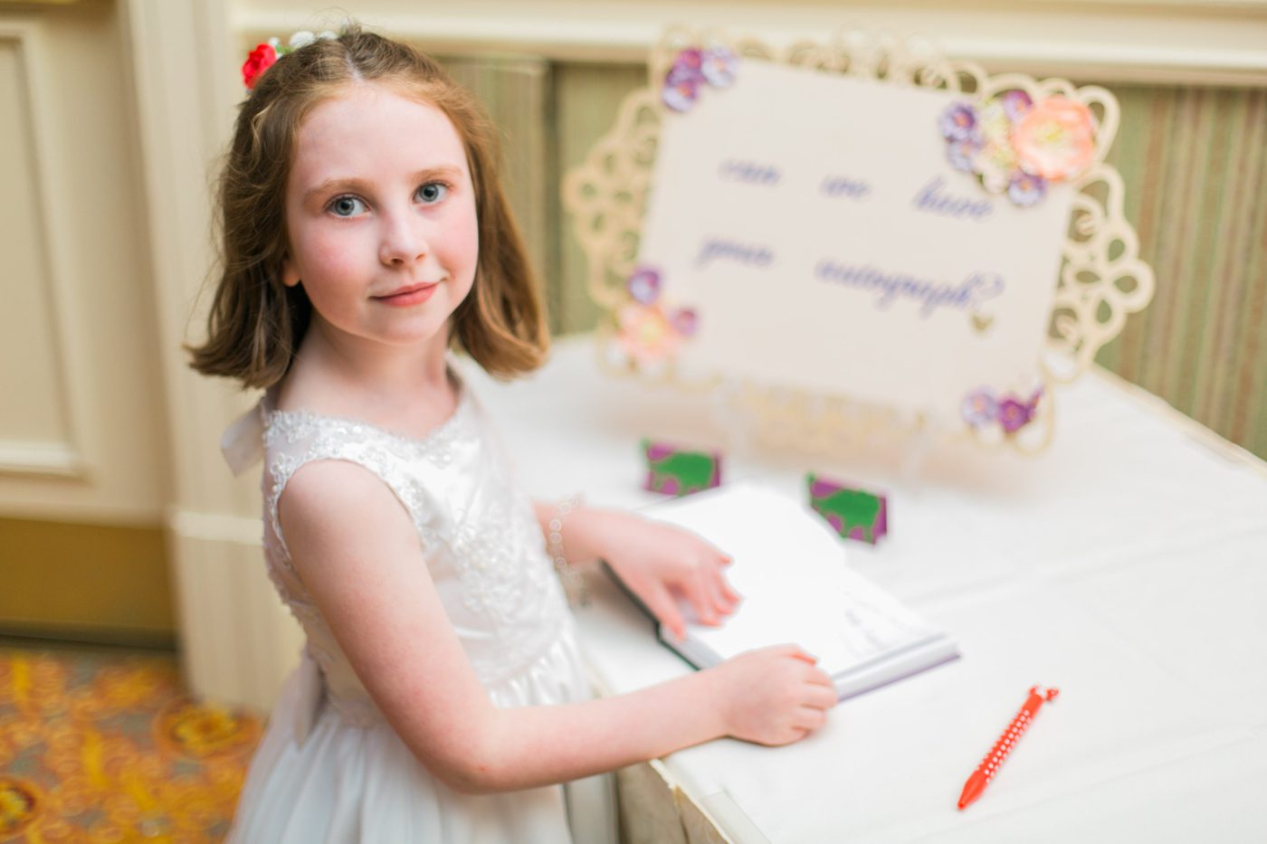 Flower girl signing the guest book 