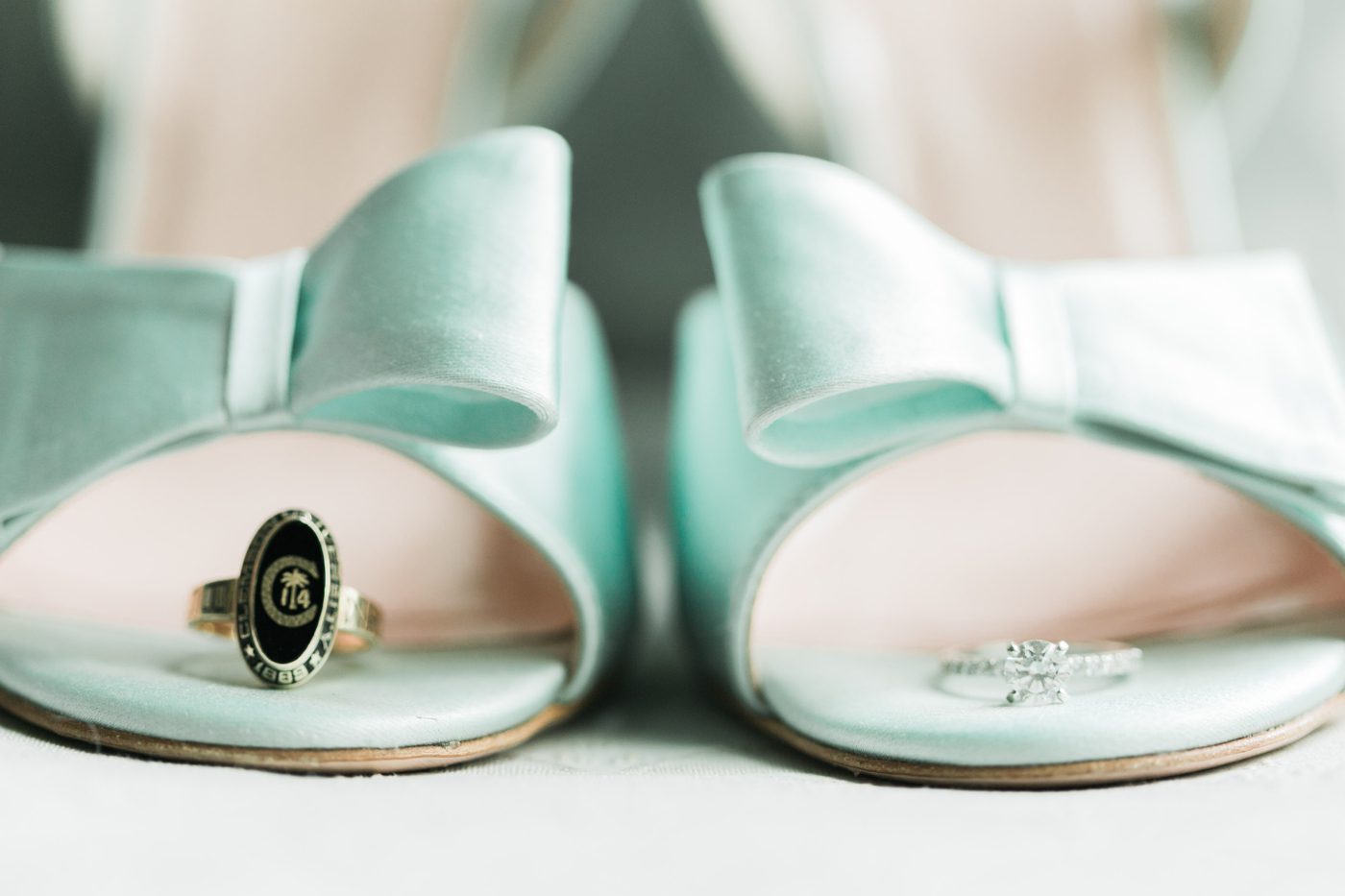 Brides engagement ring and Citadel graduation ring on her Kate Spade wedding shoes. Photo by Charleston wedding photographer Catherine Ann Photography