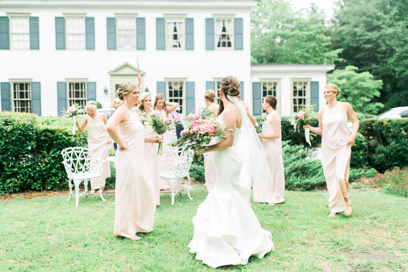 Bride and bridesmaids walking together. Photo by Charleston wedding photographer Catherine Ann Photography
