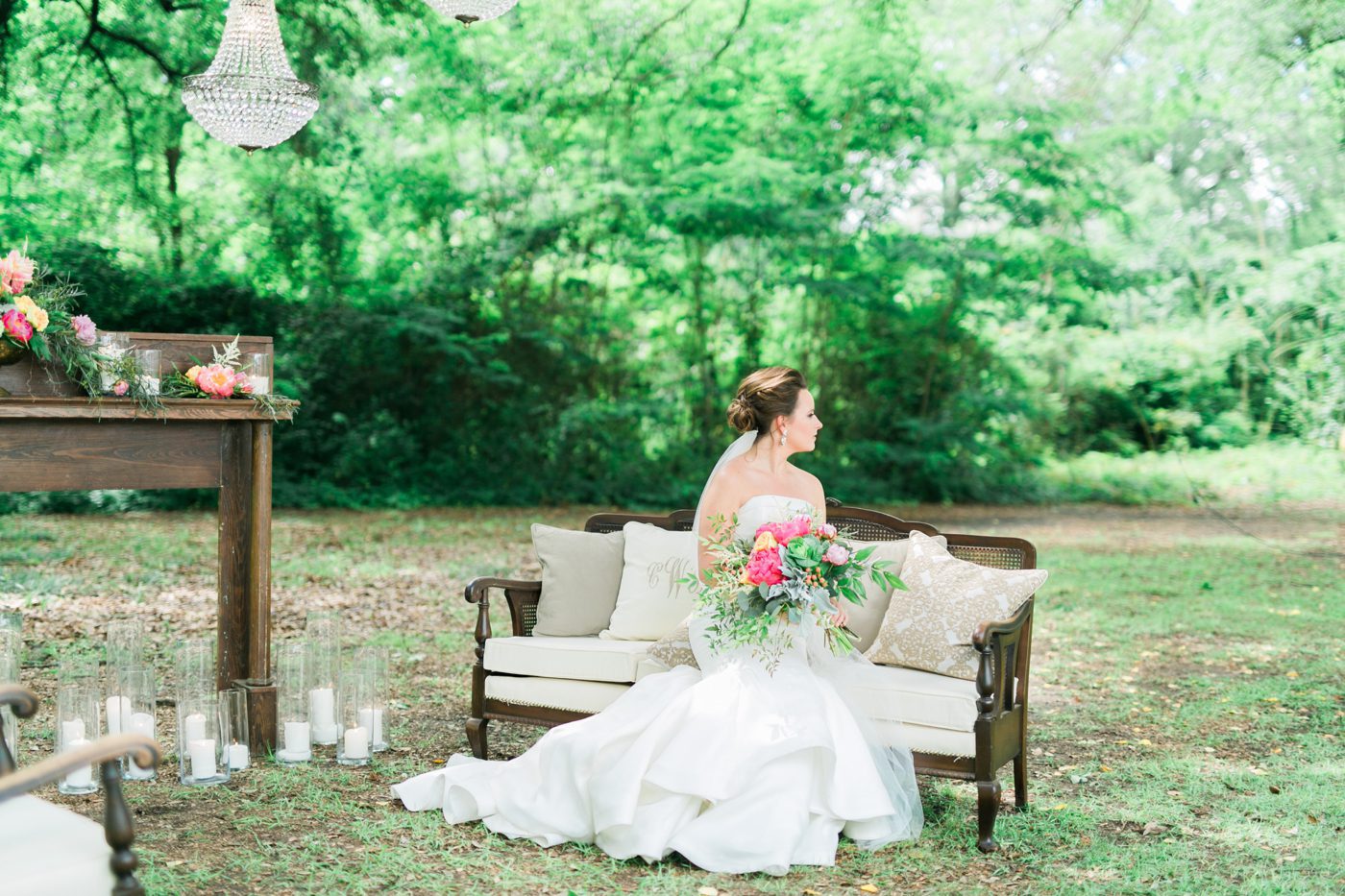 Photo of bride sitting on antique furniture with fireplace mantel and chandeliers in Hartsville SC at the Drengaelen House. Photo by Charleston bridal photographer Catherine Ann Photography