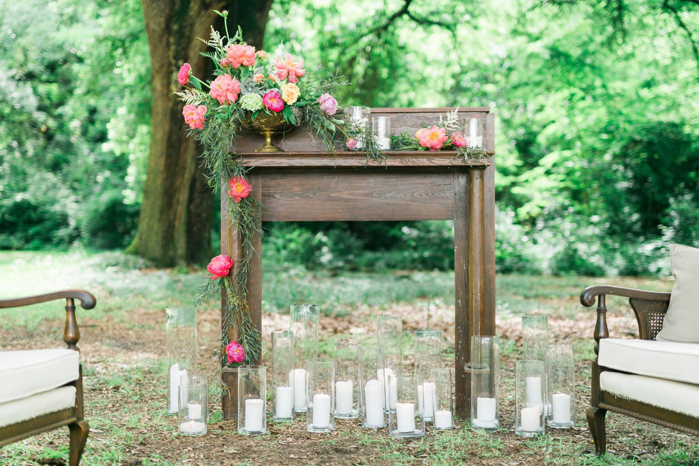 Southern wedding lounge decor with antique fireplace mantel, candles and gorgeous flowers. Photo by Charleston wedding photographer Catherine Ann Photography