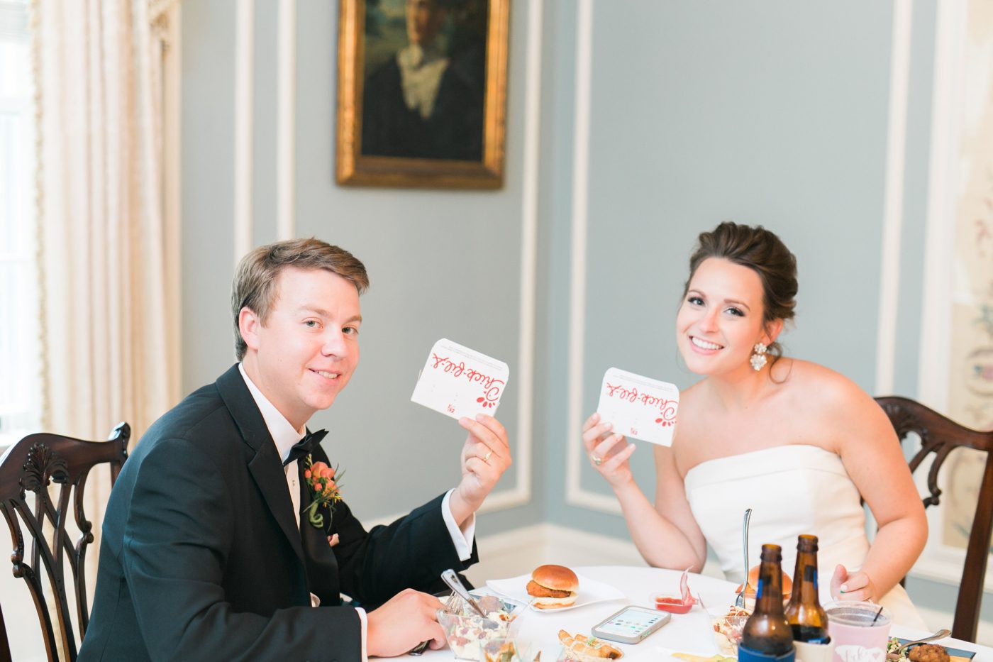 Bride and groom eating Chick Fil A. Photo by Charleston wedding photographer Catherine Ann Photography