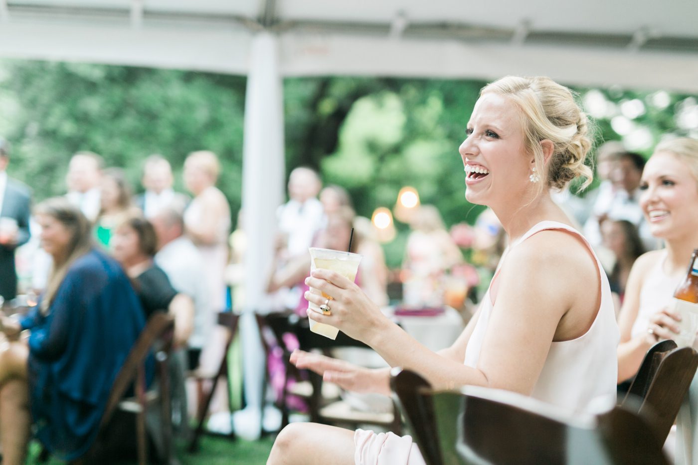 Wedding guests laughing during the toasts. Photo by Charleston wedding photographer Catherine Ann Photography