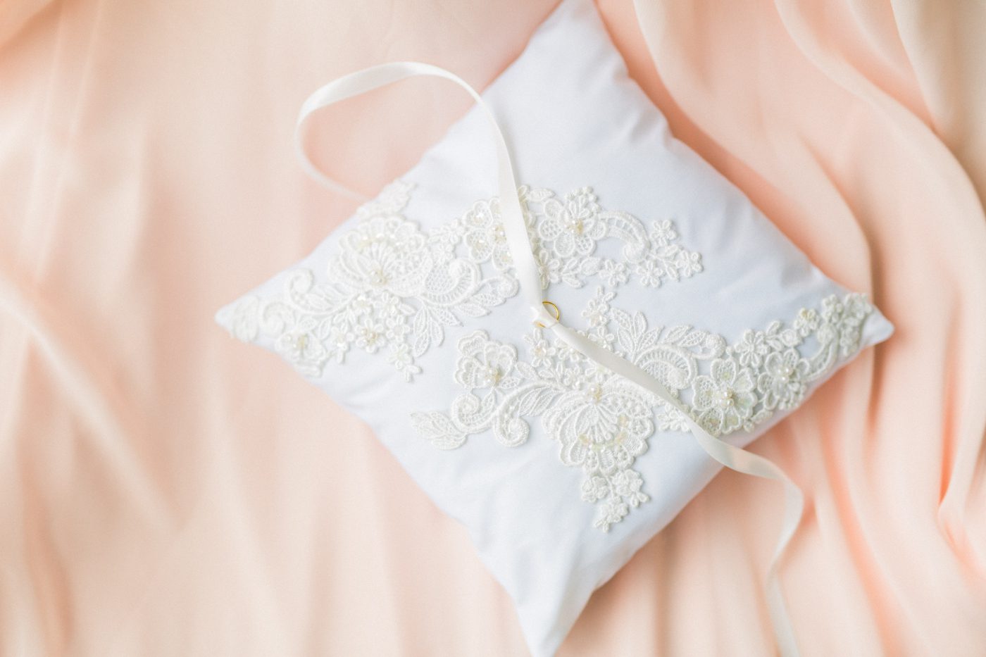 Hand made ring bearer pillow with materials from mother of the brides wedding dress . Photo by Catherine Ann Photography