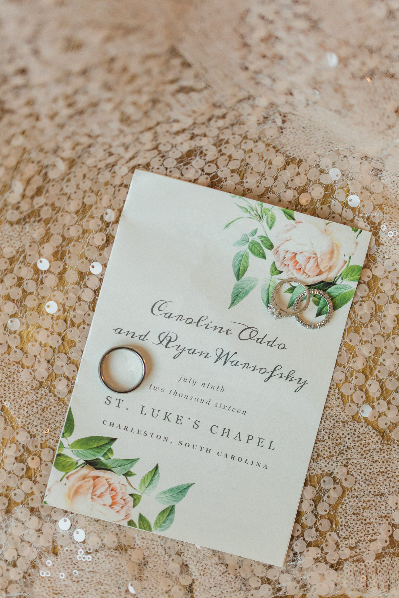 Beautiful floral wedding invitation with wedding rings and blush sequin tablecloth for a southern wedding. Photo by Catherine Ann Photography