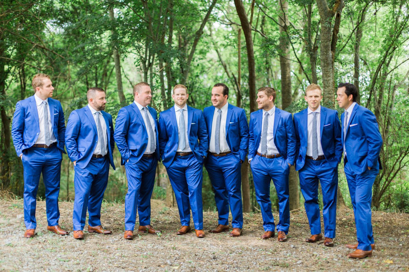 Navy blue suites and brown shoes for groom and groomsmen attire. Photo by Catherine Ann Photography