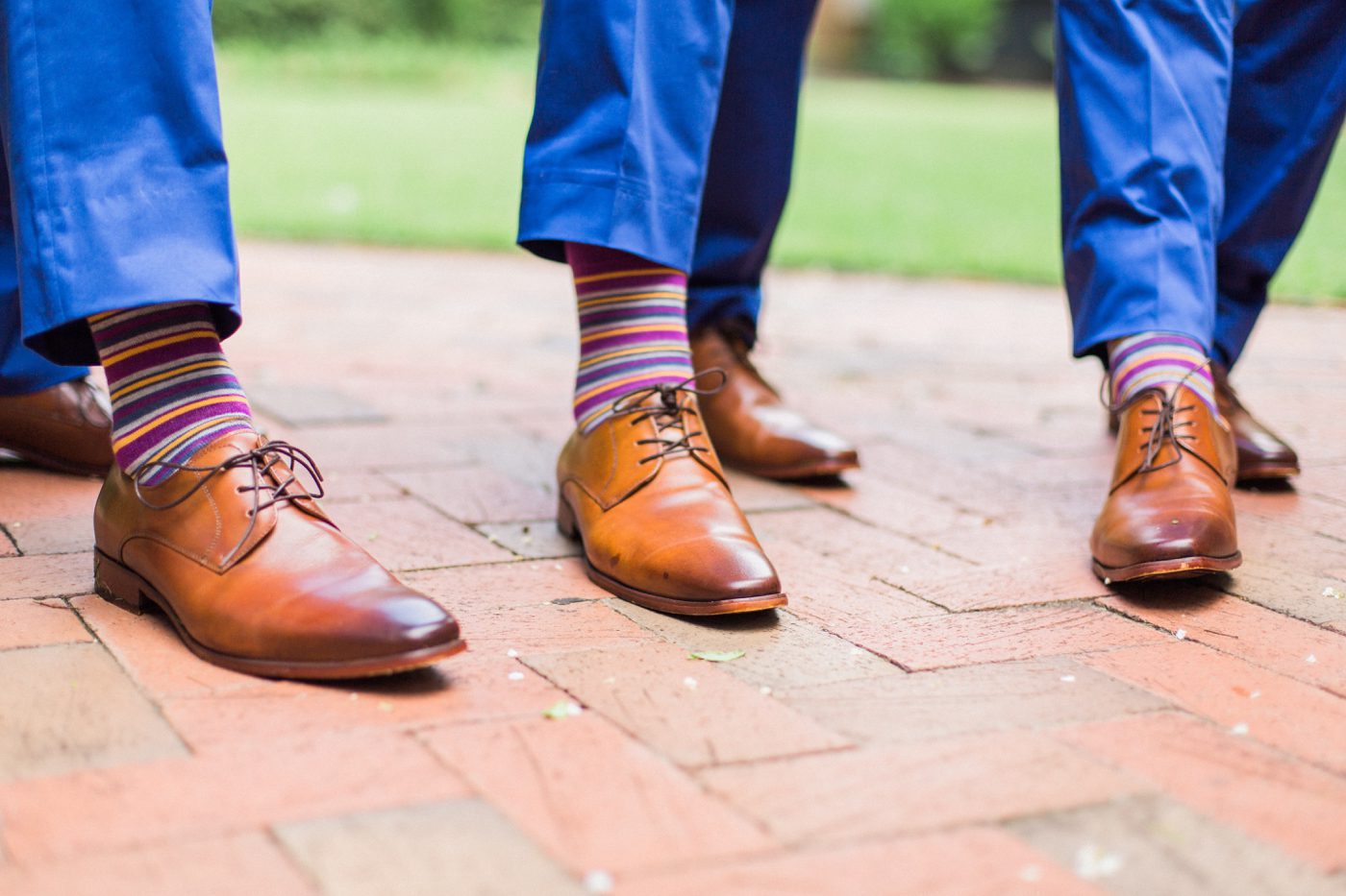 Fun groomsmen photo showing off fun striped socks. Photo by Catherine Ann Photography