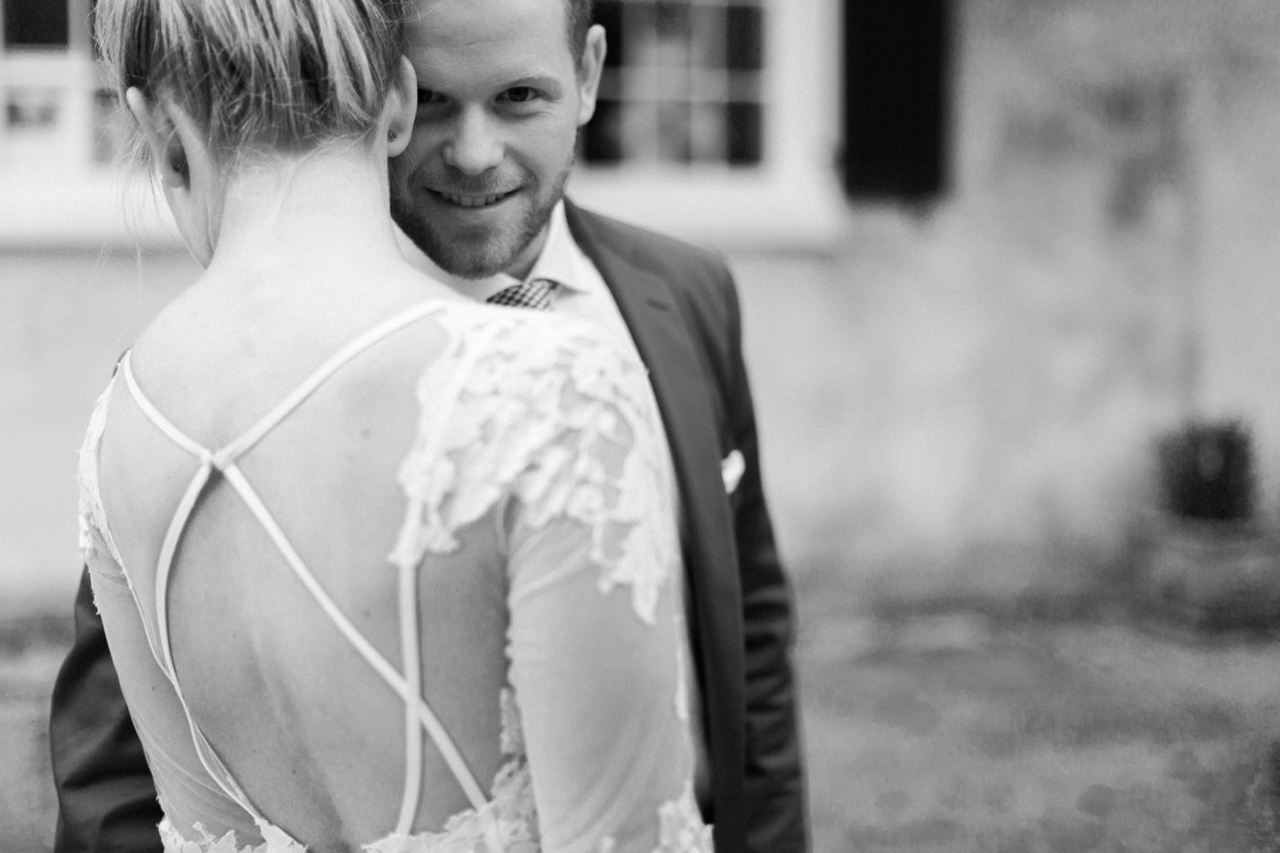 Creative wedding photography with groom looking at the camera. Photo by Catherine Ann Photography