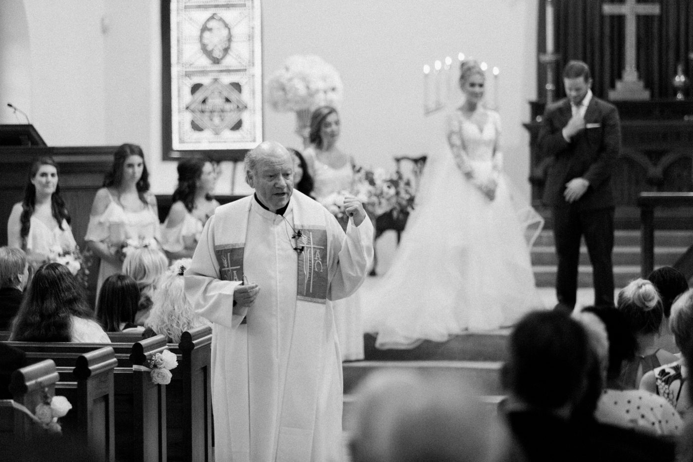 Grooms childhood priest giving a sermon during the wedding ceremony