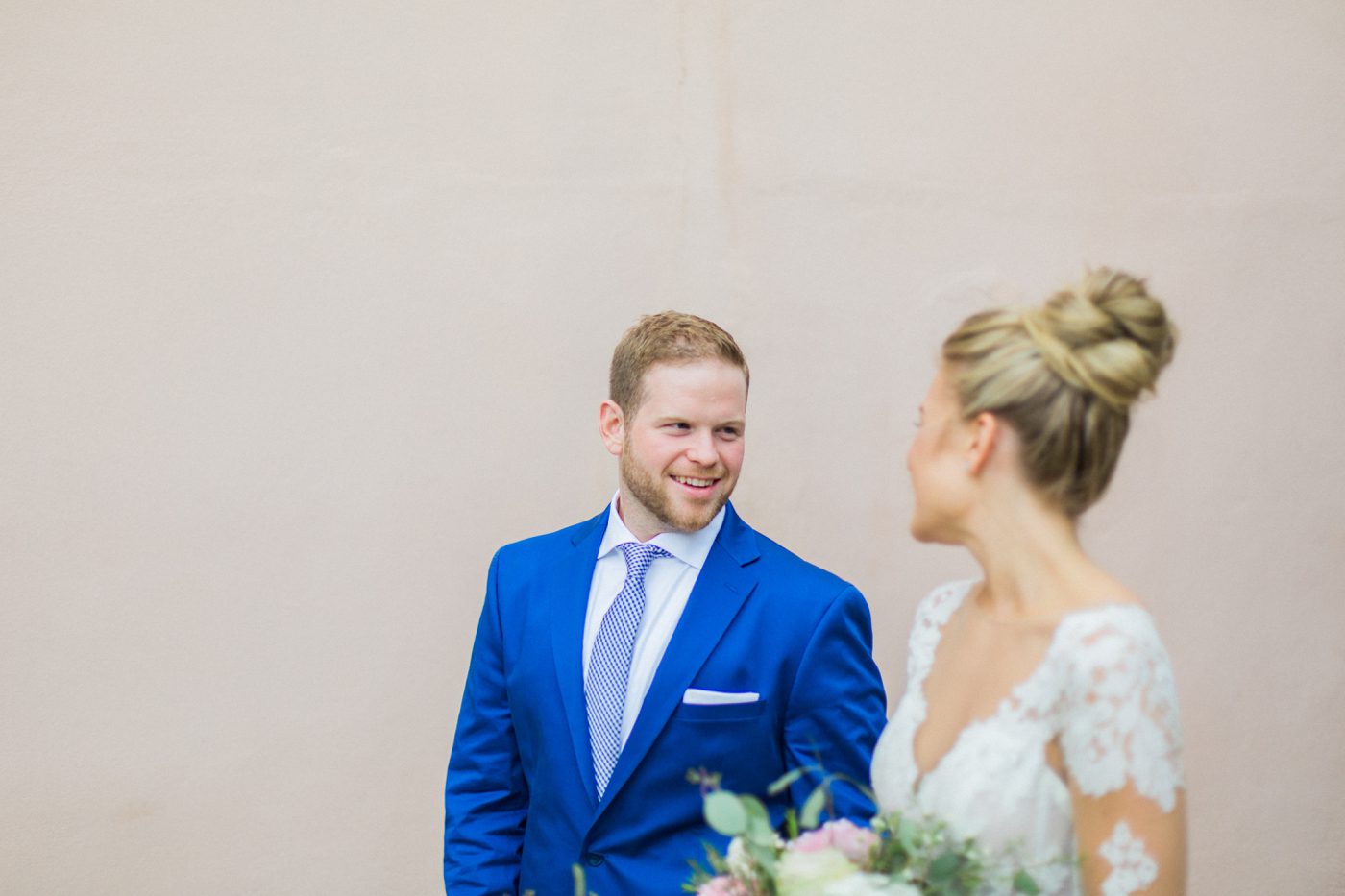 Navy blue suit for groom with checkered blue tie 