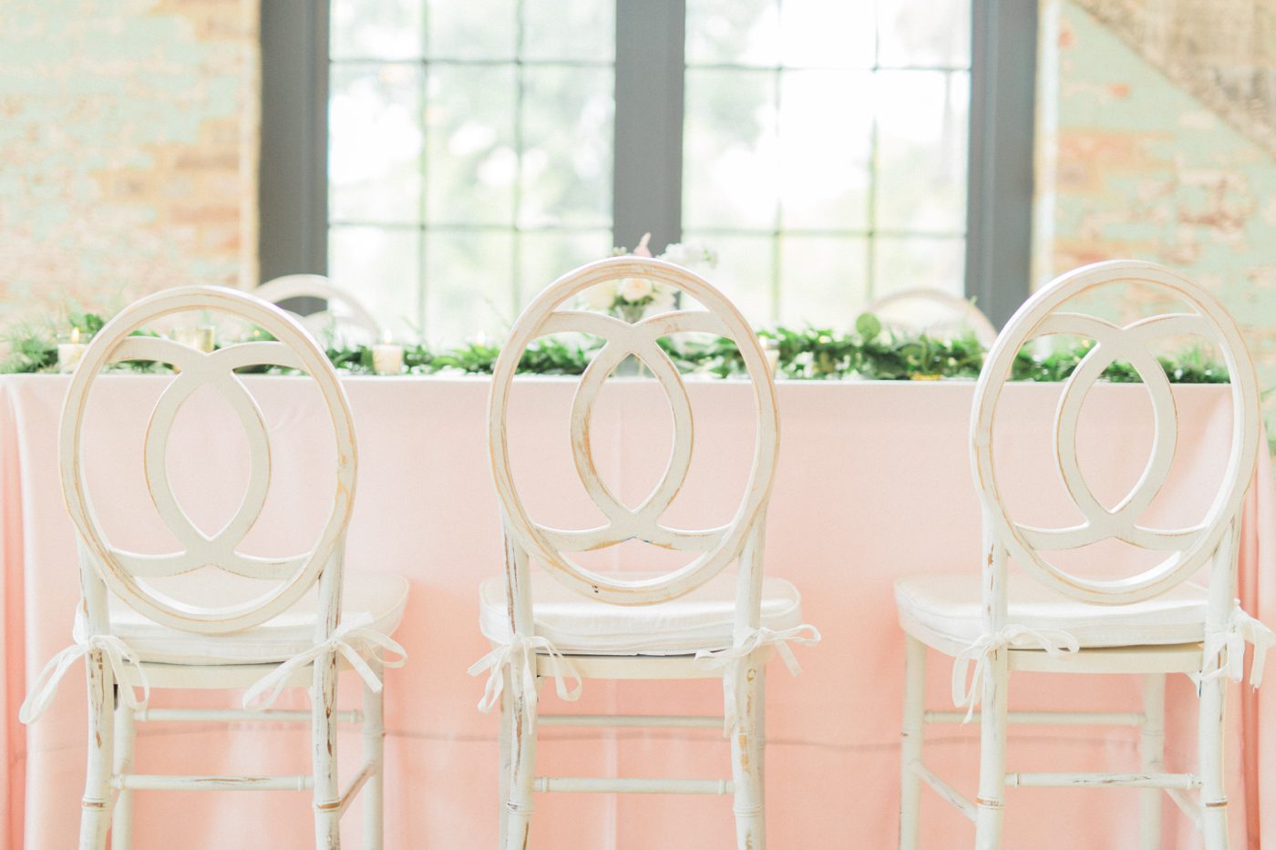 White wooden chairs and pink table cloth for romantic southern wedding reception 