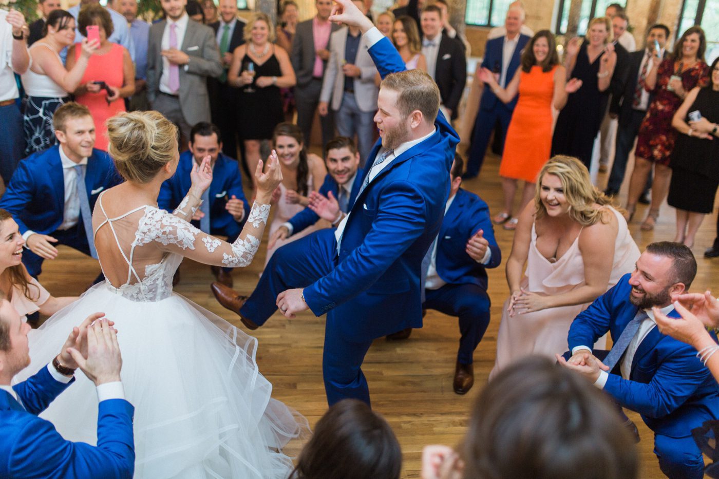 bride and groom dancing with their guests 
