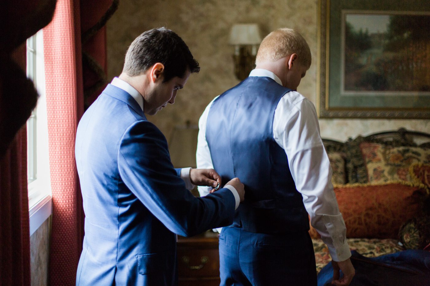 Groomsman helping the groom get ready at Stonebridge Country Club in Smithtown NY