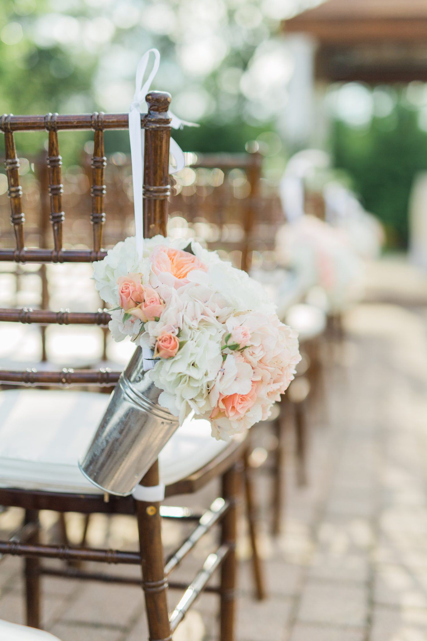 Beautiful outdoor ceremony wooden chairs with flowers
