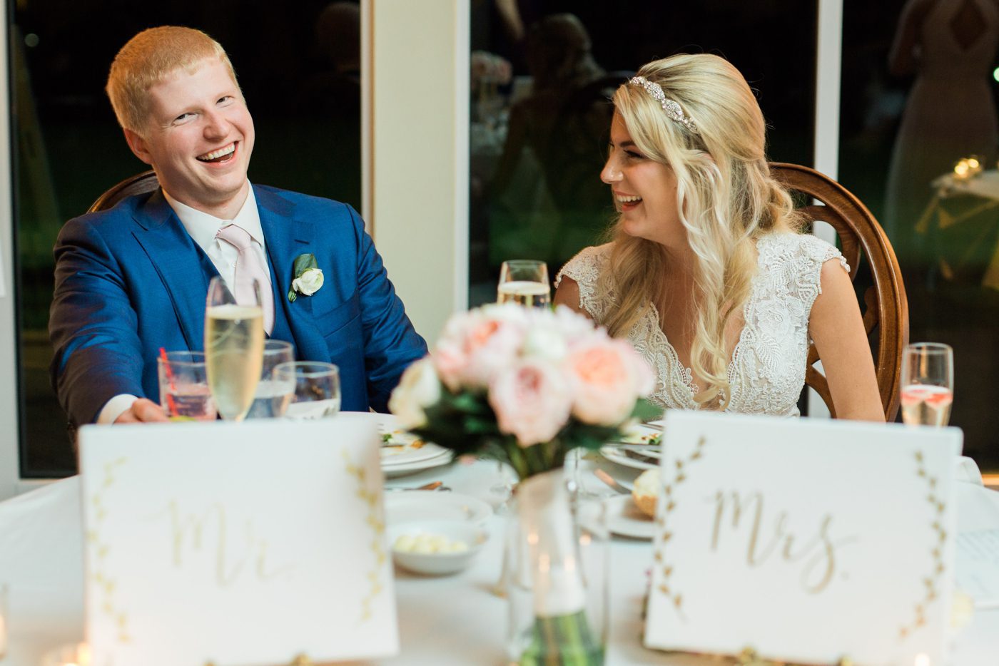 bride and groom laughing during speeches picture