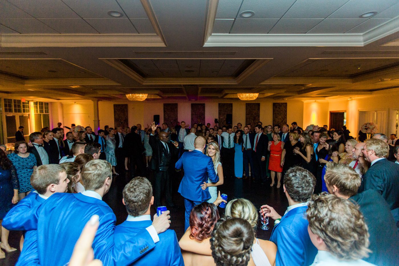 Photo of all guests surrounding bride and groom on the dance floor