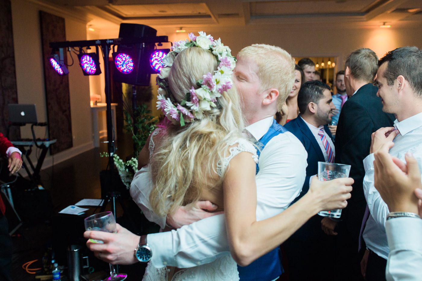 Intimate photo of groom kissing bride on dance floor