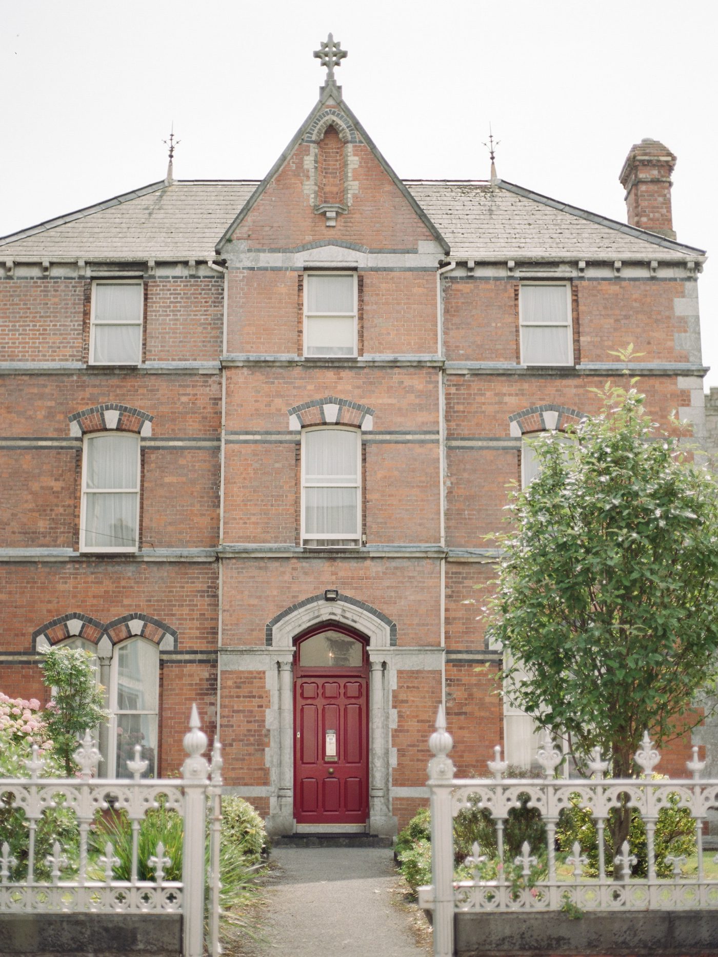Old brick victorian home with red door in Waterford Ireland