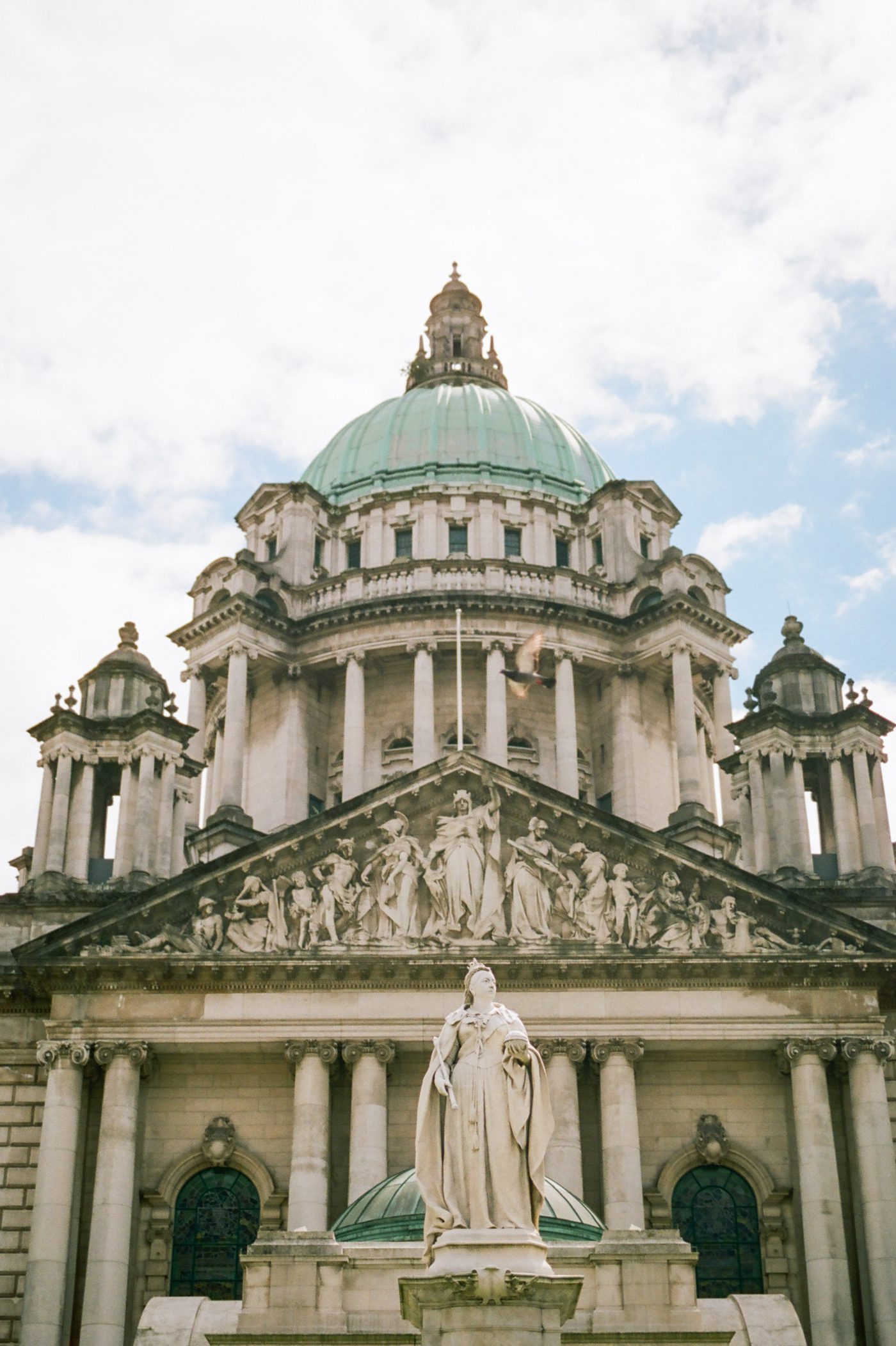Belfast Ireland city hall with Queen Victoria statue 
