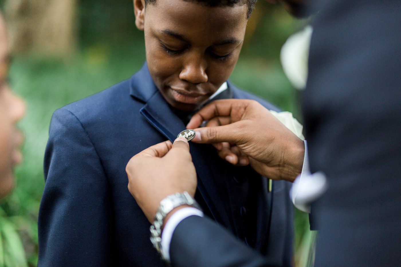 Ring bearer being pinned with batman lapel | Elegant William Aiken House Wedding Photos | Charleston SC wedding photographers Catherine Ann Photography