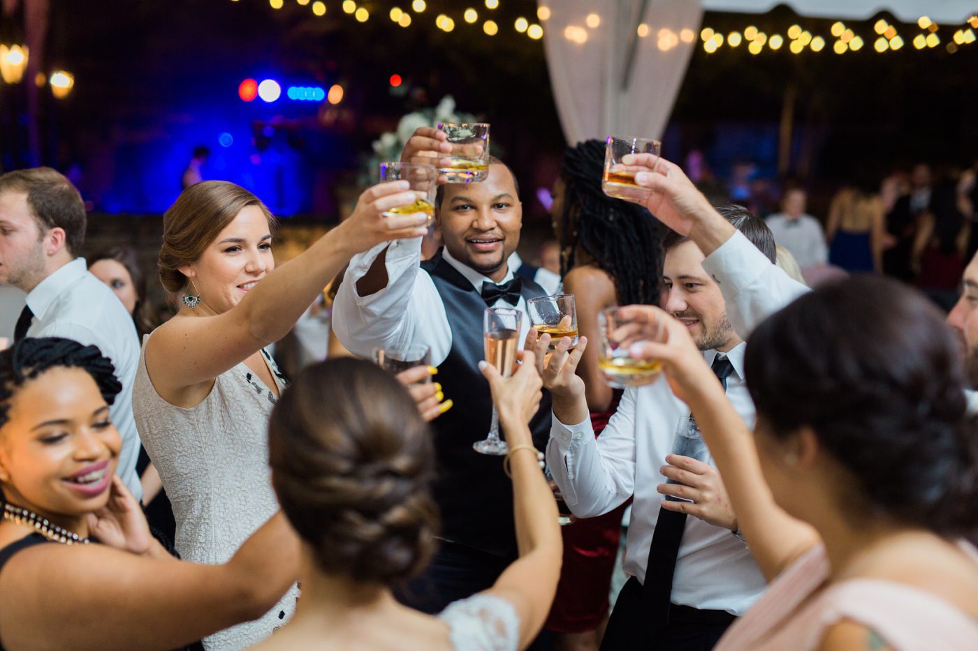 Photo toasting the bride and groom at the William Aiken House in Charleston by Catherine Ann Photography