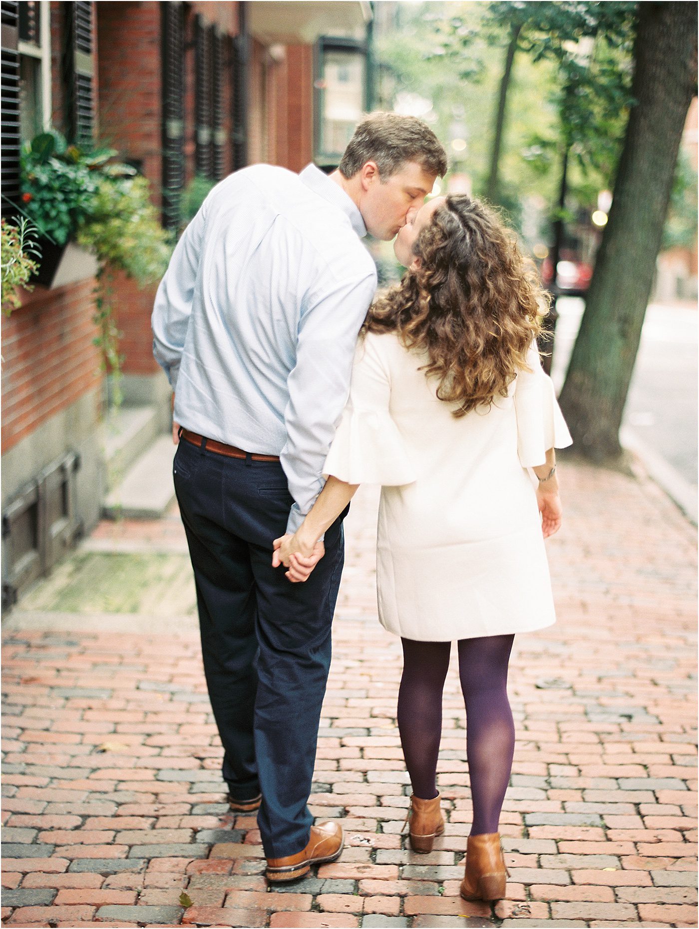Couple kissing while walking in Beacon Hill Boston MA | Catherine Ann Photography