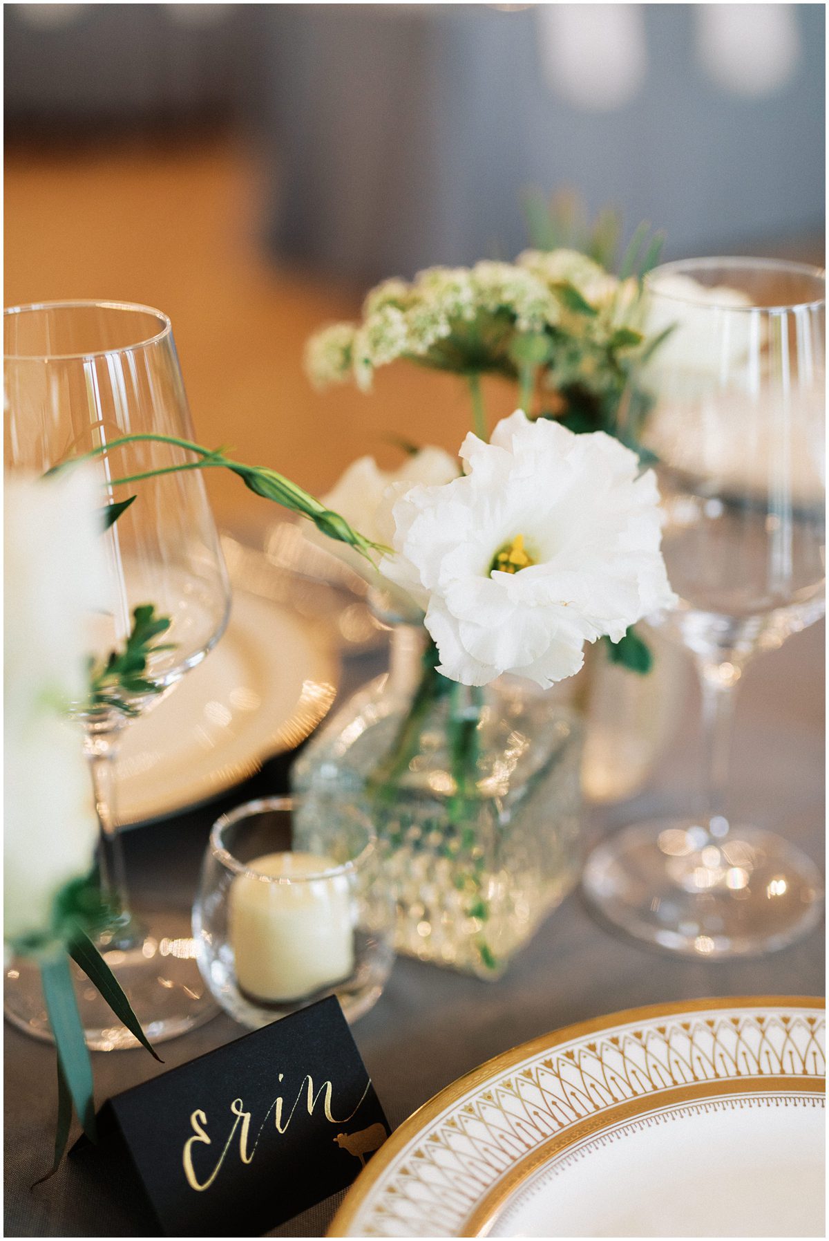 single flower in a tiny vase as wedding reception decor