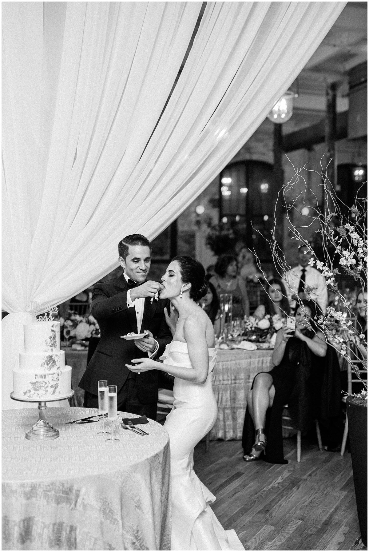 Editorial wedding photo of the Bride and groom from NYC eating cake at their Charleston SC wedding