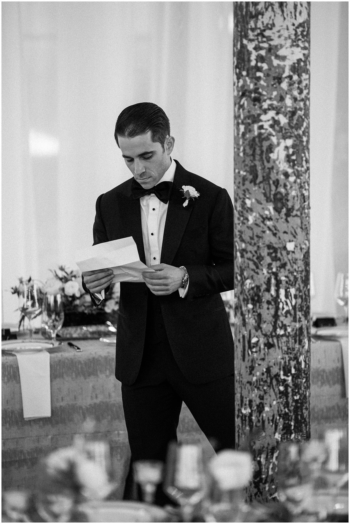 candid photo of groom reading his vows before the ceremony