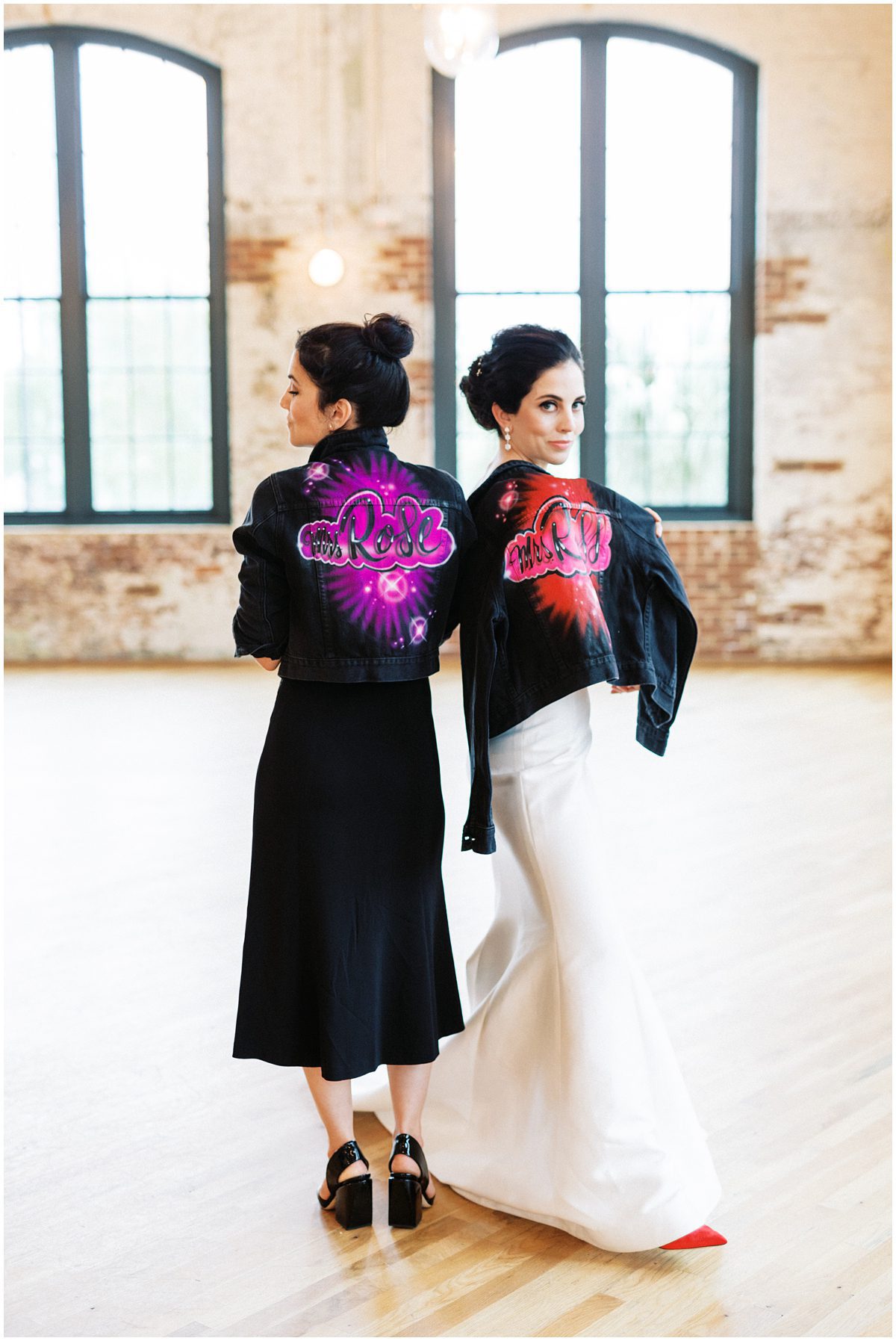 NYC bride and her sister wearing custom spray paint jackets with their last names