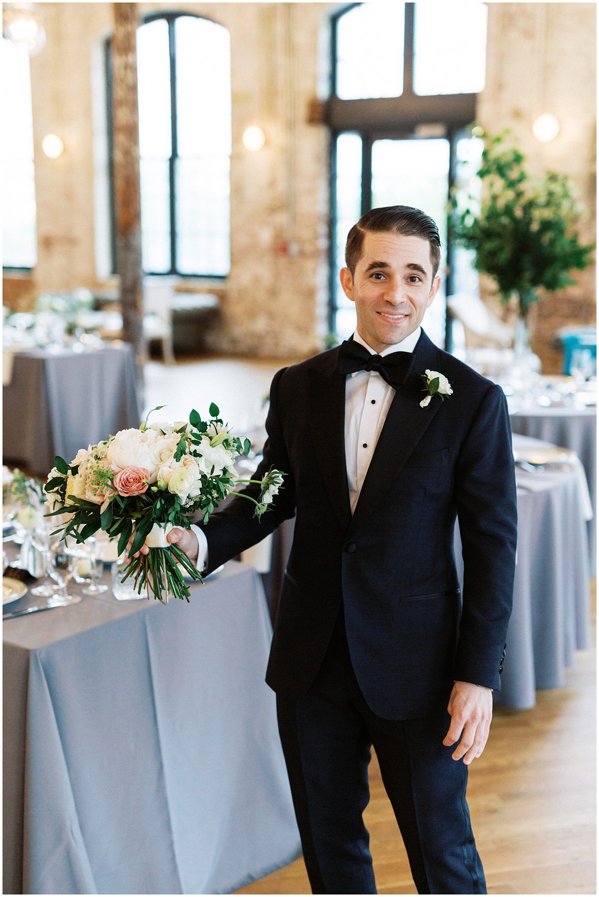cute photo of groom holding the brides bouquet