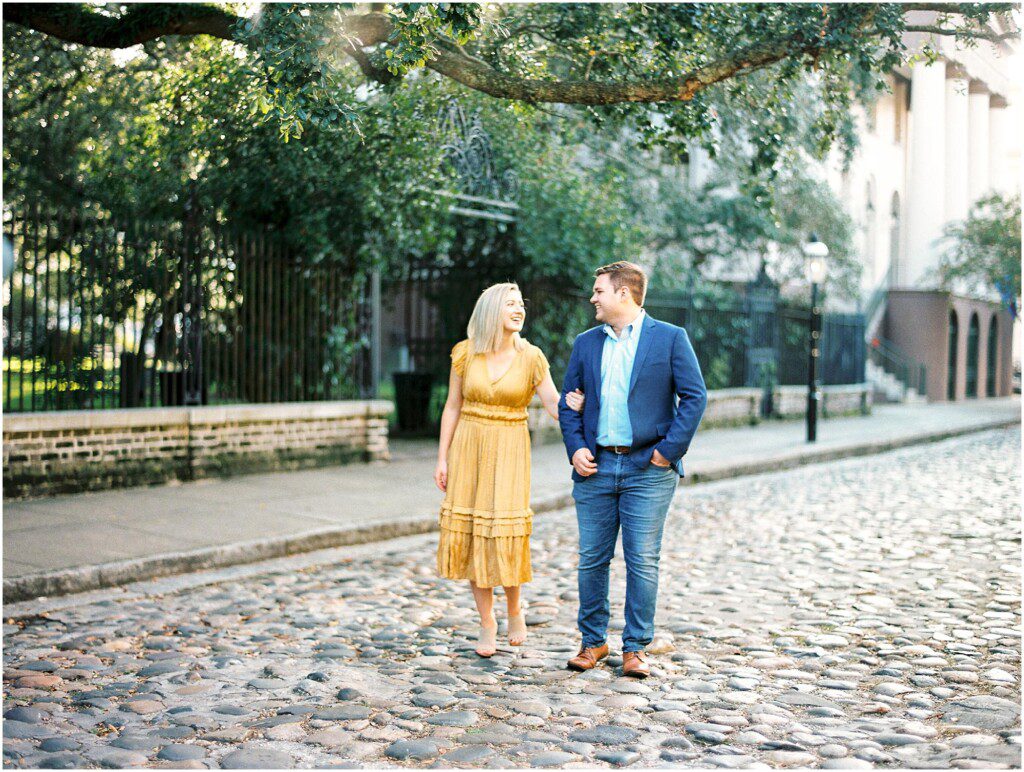 Destination engagement pictures in Charleston with yellow dress by film photographer Catherine Ann Photography