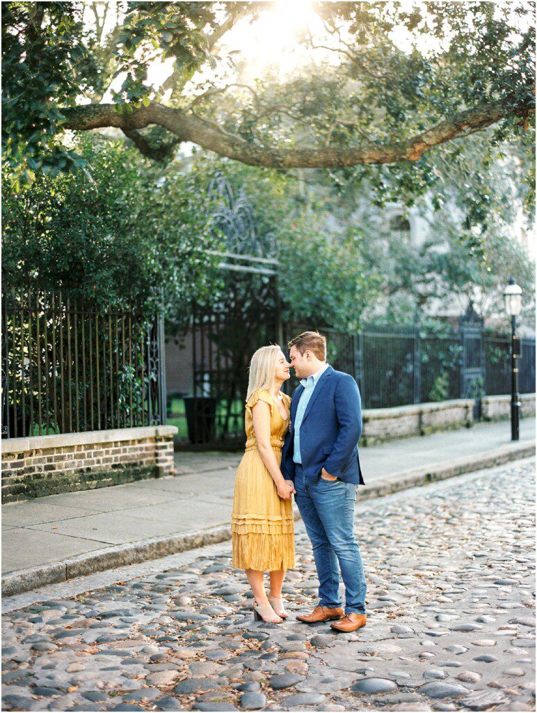 Destination engagement pictures in Charleston with yellow dress by film photographer Catherine Ann Photography
