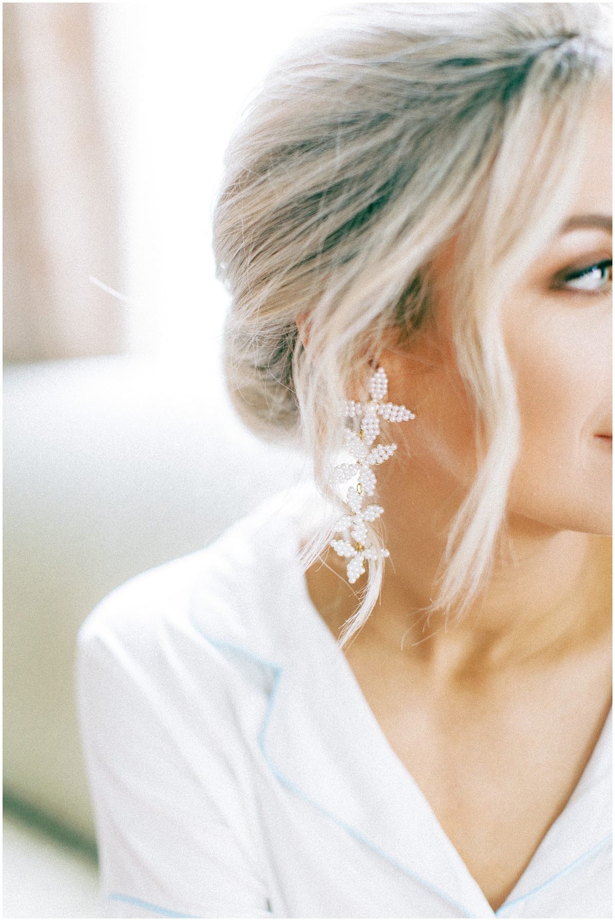 Bride wearing drop floral earrings 