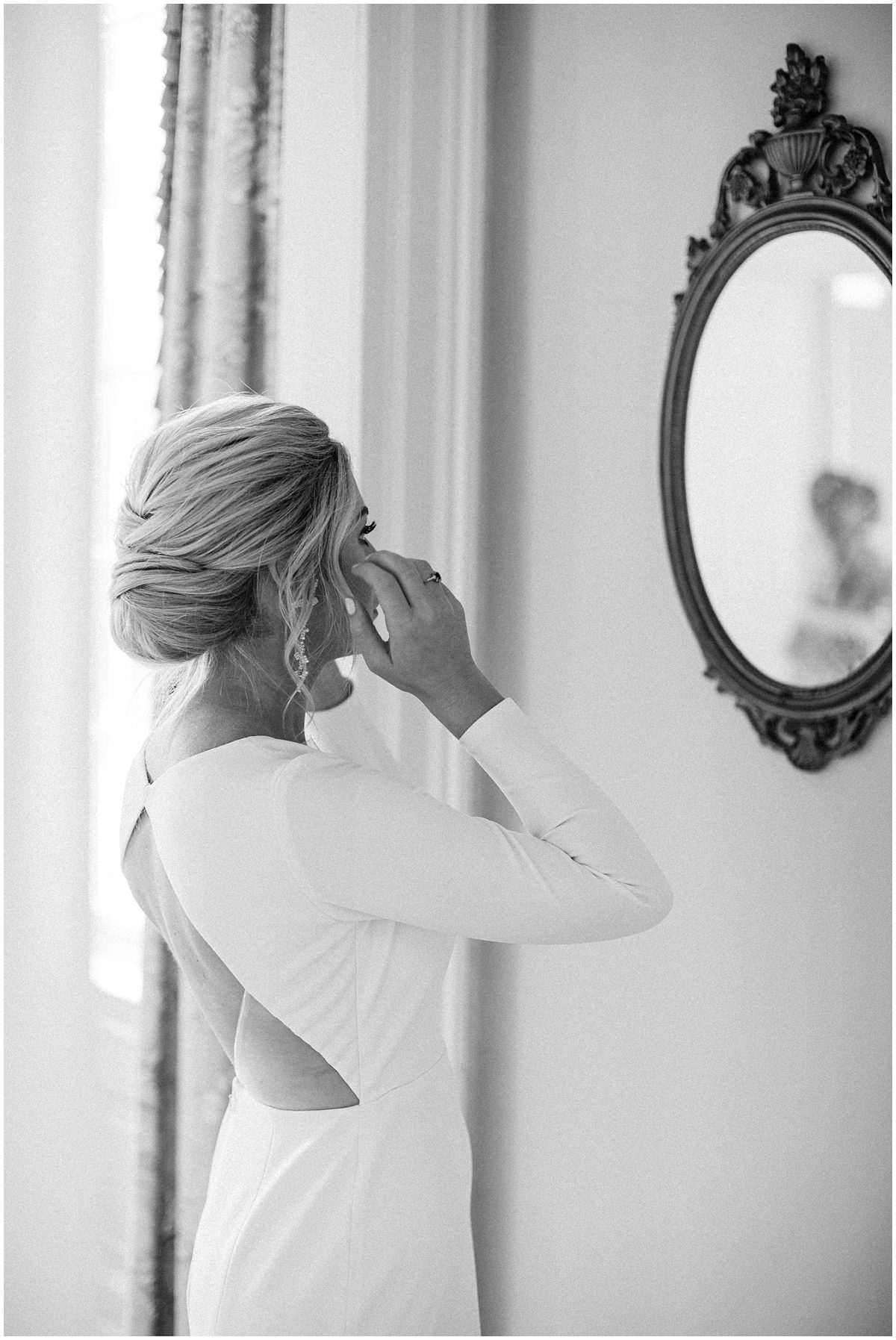 Lowndes Grove bride checking her hair in the mirror